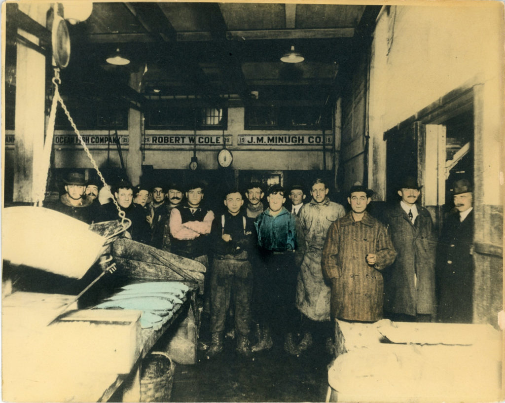 Fishmongers standing inside the Fulton Fish Market, 1933
