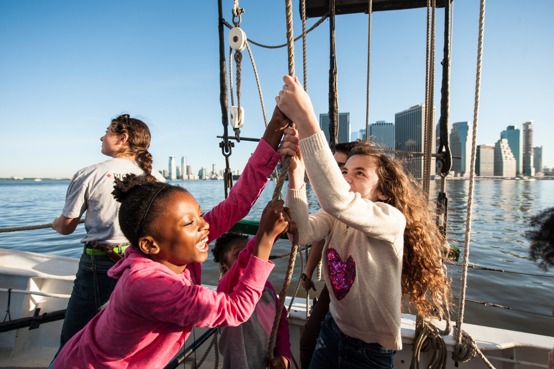 Children help raise Pioneer's sails