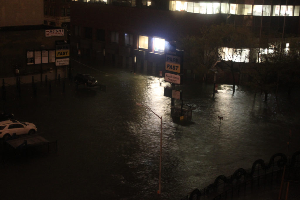 Nighttime photograph of the devastation of Hurricane Sandy on John Street