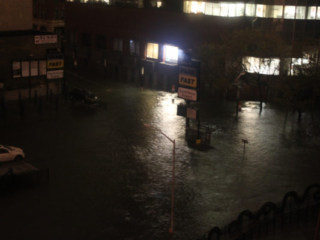 Nighttime photograph of the devastation of Hurricane Sandy on John Street