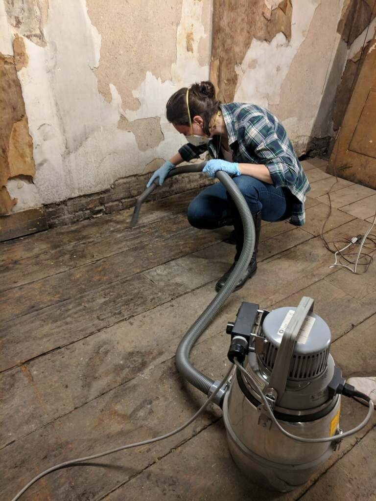 Collections professional vacuuming dust in Roger’s Hotel and Dining Saloon, 2018