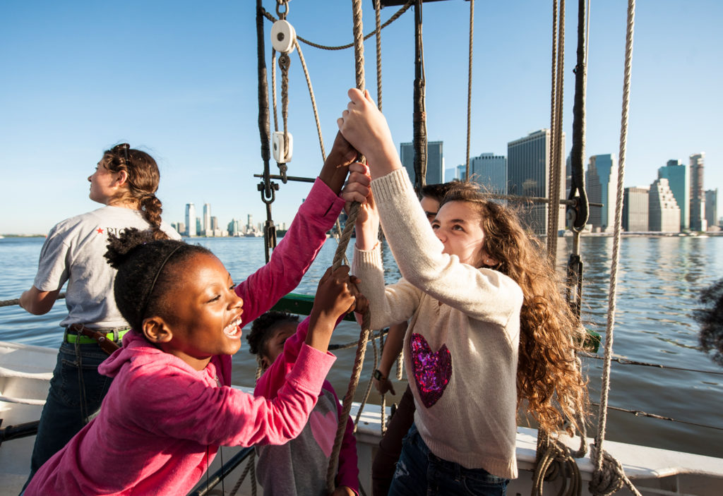 Raising sails on schooner Pioneer