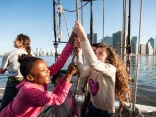 Raising sails on schooner Pioneer