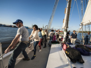 Raising sails on schooner Pioneer