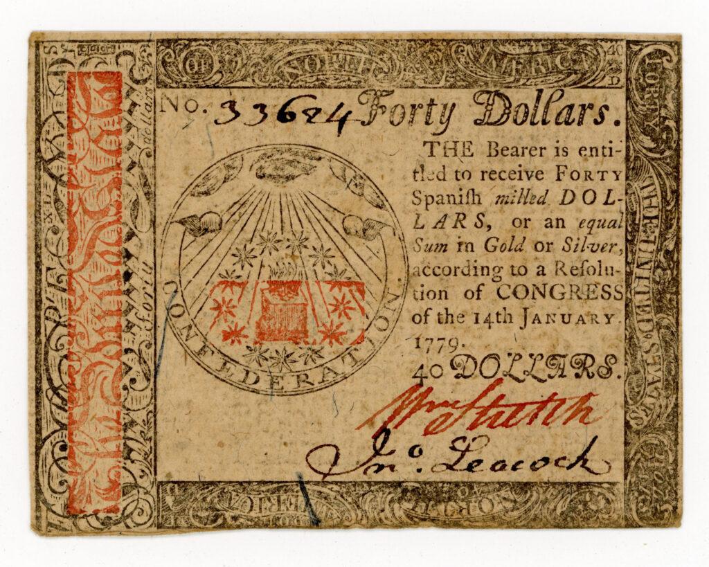 Small piece of paper, or banknote, for forty dollars, with a handwritten signature. Between words and graphic borders there is an illustration of an eye with rays being emitted from it in a pyramid shape. Surrounding the illustration is the word "CONFEDERATION." Printed in both black and red ink.
